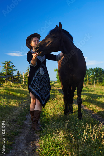 Beautiful girl with horse on the sunset