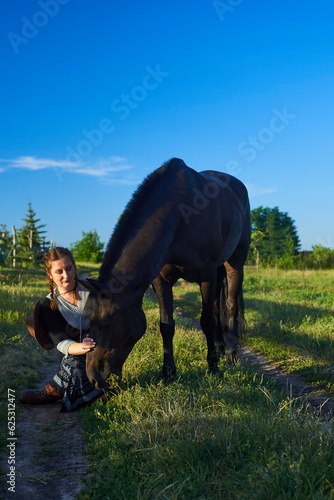 Beautiful girl with horse on the sunset