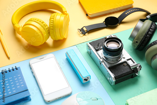 Composition with different gadgets on color background