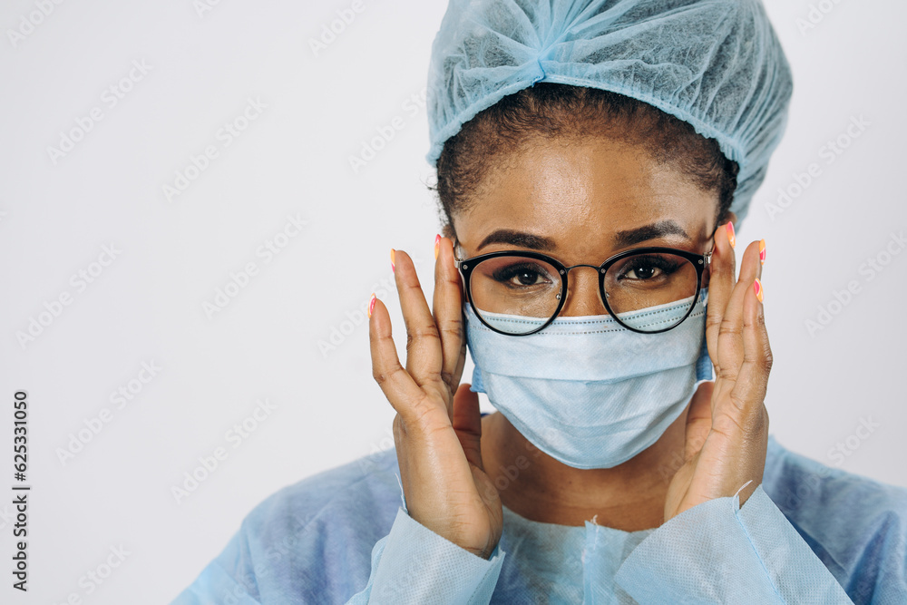 Portrait of young female african american doctor or nurse woman on medical protective wear with mask Portrait of young female african american doctor or nurse woman on medical protective wear with mask