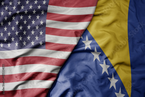 big waving colorful flag of united states of america and national flag of bosnia and herzegovina .