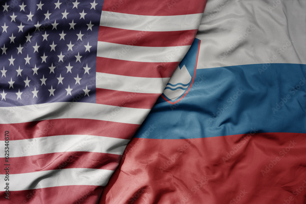 Obraz premium big waving colorful flag of united states of america and national flag of slovenia .
