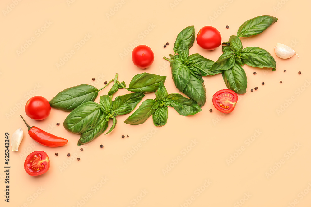 Fresh basil, cherry tomatoes and peppercorn on orange background Fresh basil, cherry tomatoes and peppercorn on orange background