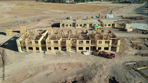 Casa Grande, Arizona, USA- June 4, 2023:  Aerial view of a new apartment complex at various stages of construction including site preparation, underground utilities, and post tensioned rods.  photo