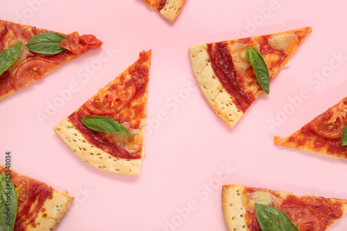 Slices of tasty pizza on pink background
