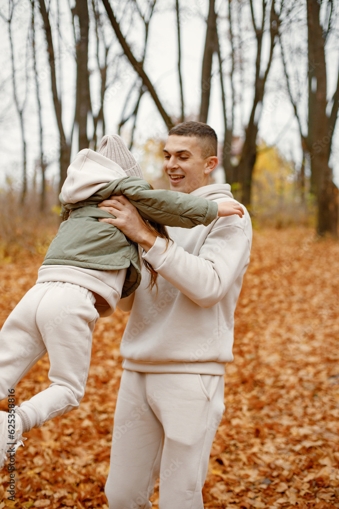 Fototapeta premium Father with his daughter playing in autumn forest
