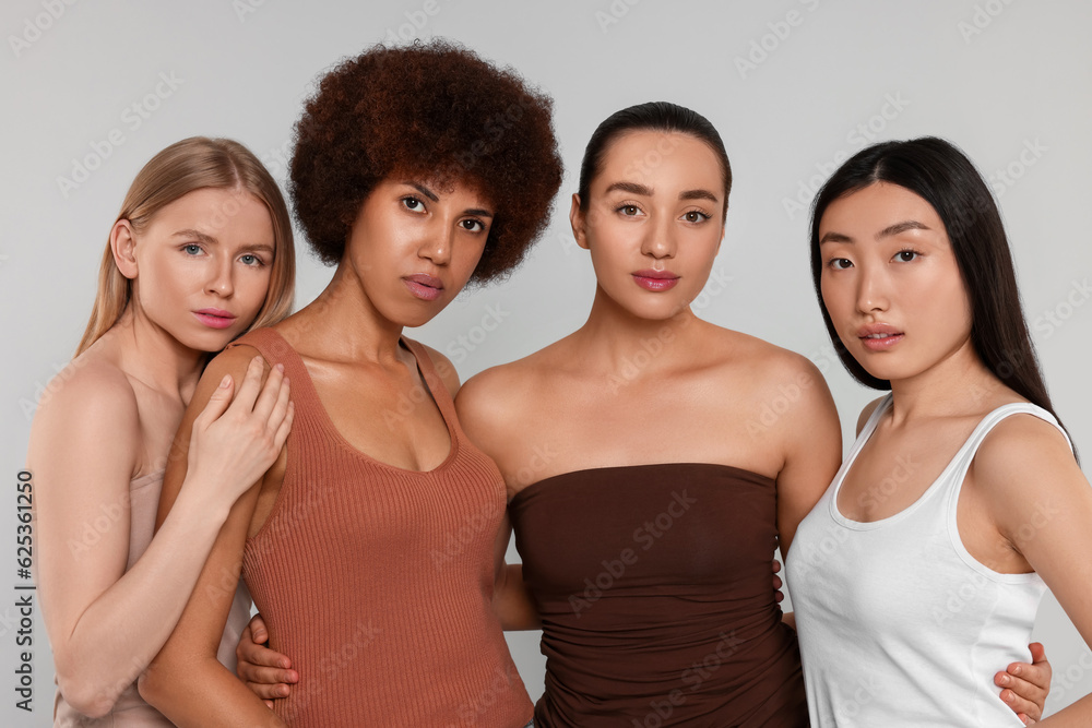 Portrait of beautiful young women on light grey background Portrait of beautiful young women on light grey background