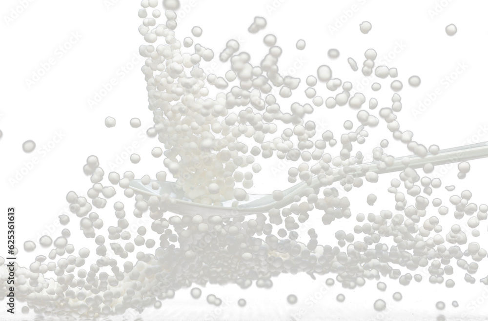 Sago seeds falling down from measure cup, white grain wave floating, Abstract fly splash in air. White Sago seeds is material food. Black background isolated selective focus blur