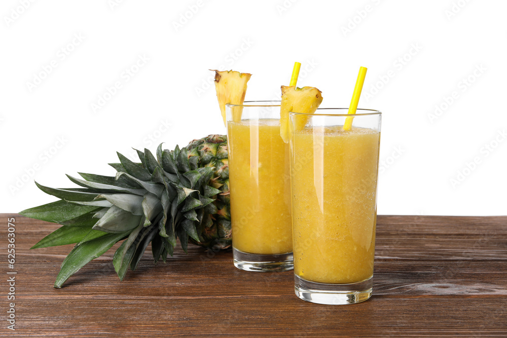 Tasty pineapple smoothie and fresh fruit on wooden table against white background Tasty pineapple smoothie and fresh fruit on wooden table against white background