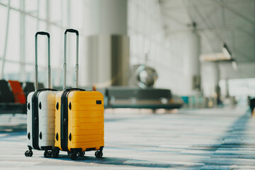 Two suitcases in an empty airport hall, traveler cases in the departure airport terminal waiting for the area, vacation concept, blank space for text message or design