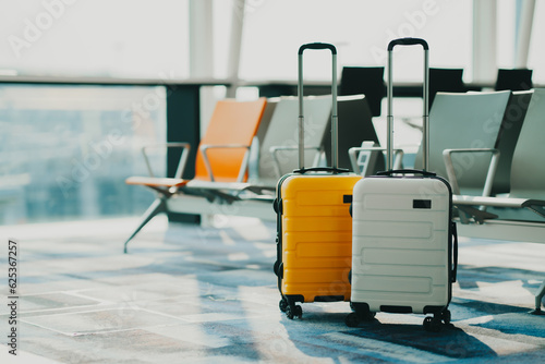 Two suitcases in an empty airport hall, traveler cases in the departure airport terminal waiting for the area, vacation concept, blank space for text message or design