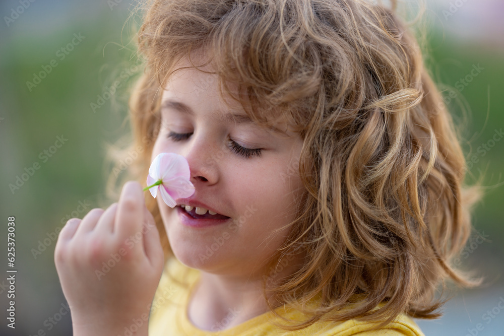 Kids smelling summer flower, closeup face. Funny summer, child face close up. Kids head portrait. Kid enjoying nature. Portrait cute boy in summer. Head shoot kids summer portrait outdoor. Kids smelling summer flower, closeup face. Funny summer, child face close up. Kids head portrait. Kid enjoying nature. Portrait cute boy in summer. Head shoot kids summer portrait outdoor.