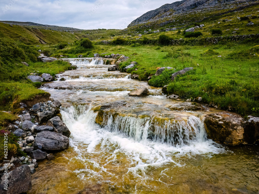 Peaceful cascade river flow irish landscape in summer Peaceful cascade river flow irish landscape in summer
