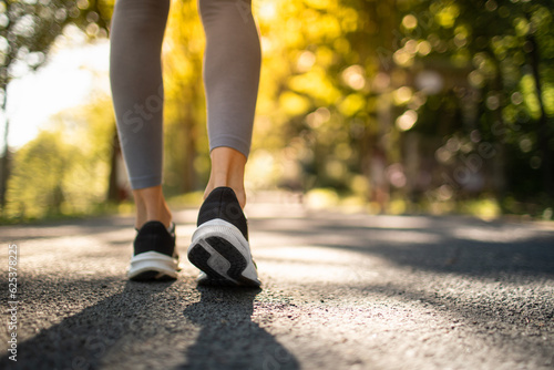 Active woman jogging walking outdoors in sunlight © kieferpix