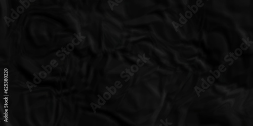 Black fabric background. Black crumpled  and wrinkled paper texture crush paper so that it becomes creased and wrinkled. Old black crumpled paper sheet background texture.  