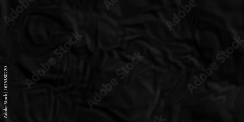 Black fabric background. Black crumpled  and wrinkled paper texture crush paper so that it becomes creased and wrinkled. Old black crumpled paper sheet background texture. 	