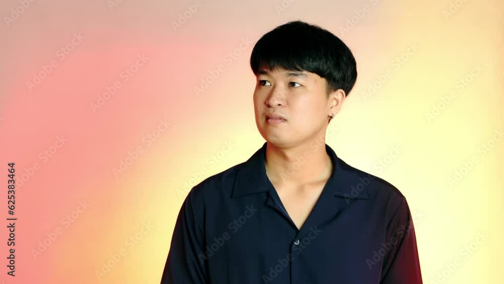 Virtual Reality AR concept. Front view of a young asian man touching something on virtual screen, neon orange background. Virtual Reality AR concept. Front view of a young asian man touching something on virtual screen, neon orange background.