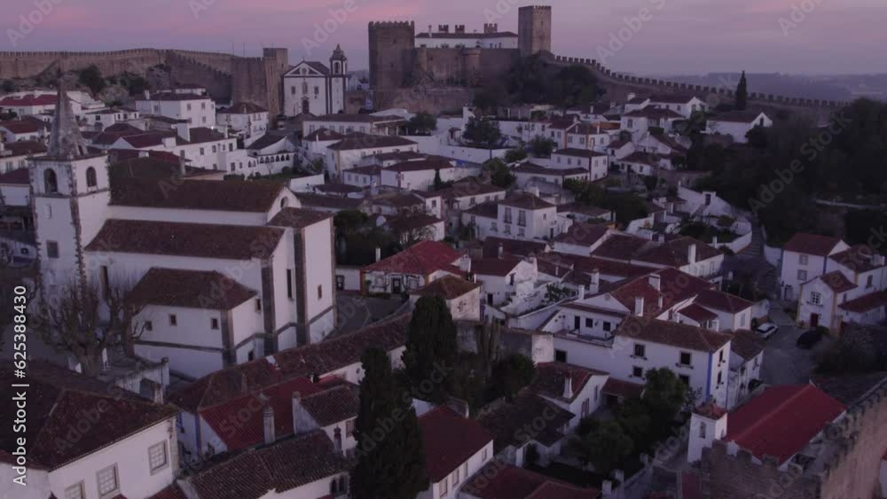 Reveal shot of medieval town Obidos Portugal during sunrise. aerial Reveal shot of medieval town Obidos Portugal during sunrise. aerial