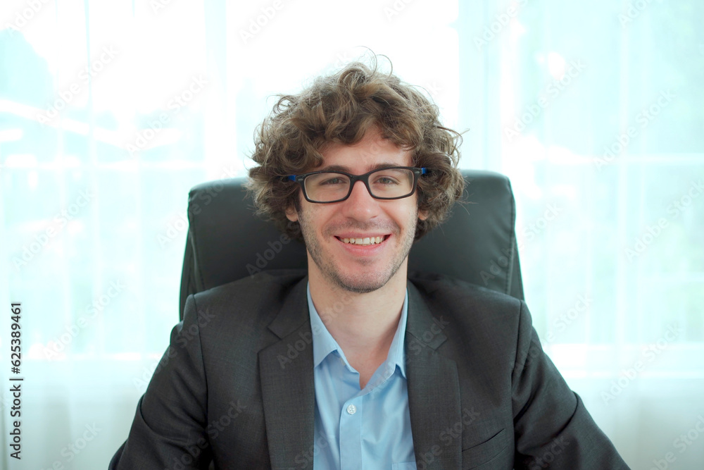 Smart - good looking senior caucasian white businessman speaking to the camera in his office. Smart - good looking senior caucasian white businessman speaking to the camera in his office.