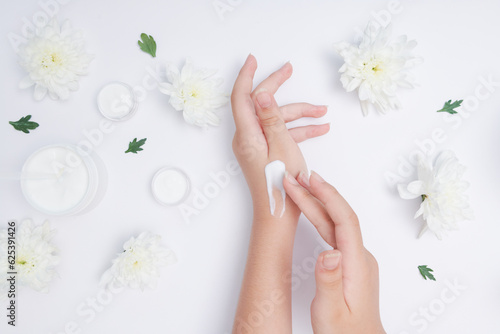Moisturizing care skincare face cream for healing complicated troubled skin type. girl smears her hands cosmetic cream. skin care  elastic and young skin of the hands. flat lay  top view.