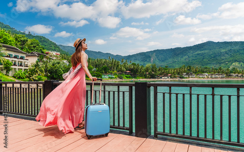Happy traveler woman in pink dress with suitcase joy nature scenic landscape island beach in blue sky, Leisure tourist travel Thailand summer holiday vacation trip, Tourism beautiful destination Asia