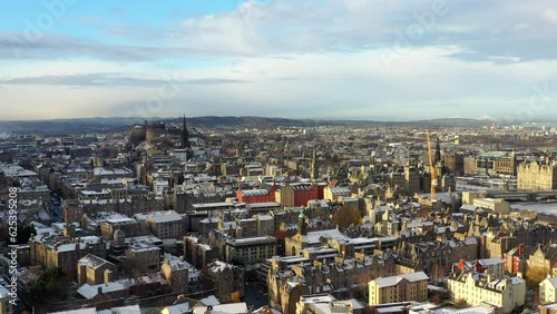 Aerial shot of Edinburgh castle and skyline covered in snow on a crisp sunny winters day. photo