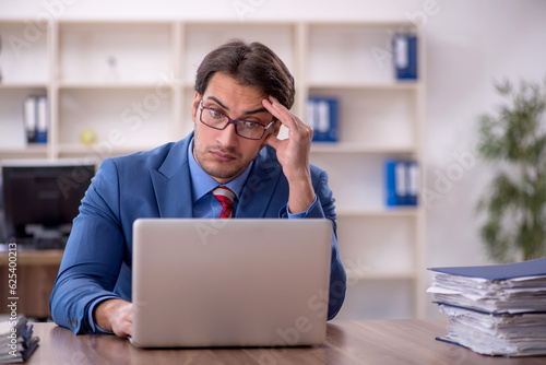 Young male employee working in the office