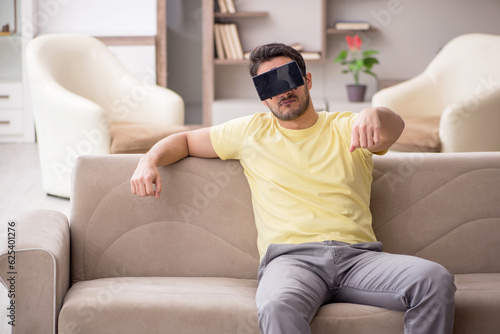 Young man enjoying virtual glasses at home