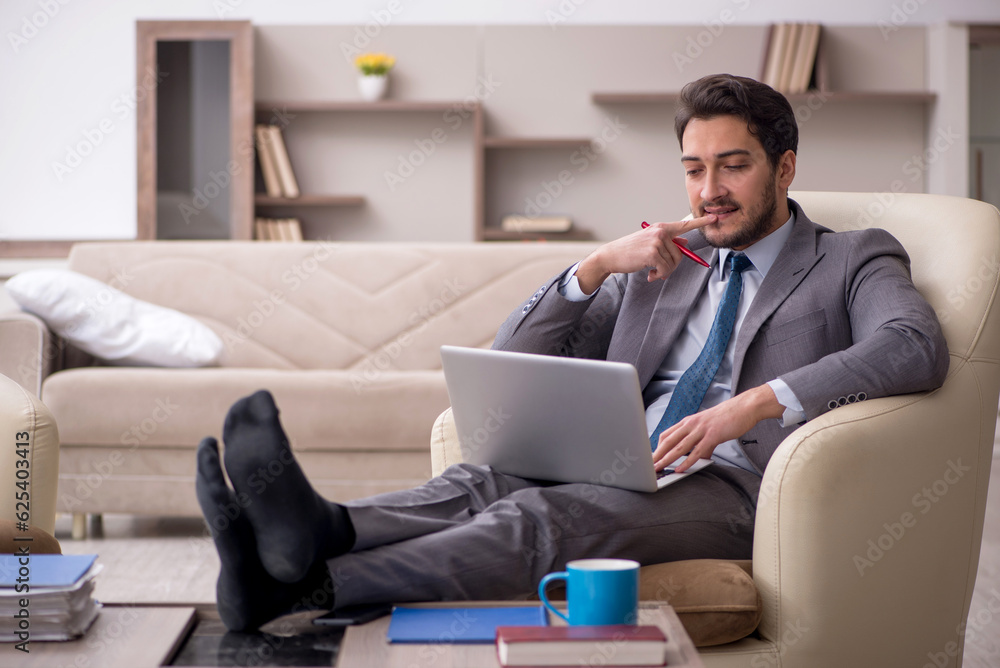 Young male employee working from home