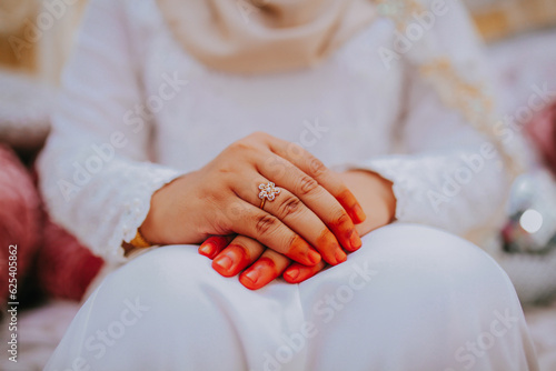 Young bride wearing beautiful wedding ring, closeup.