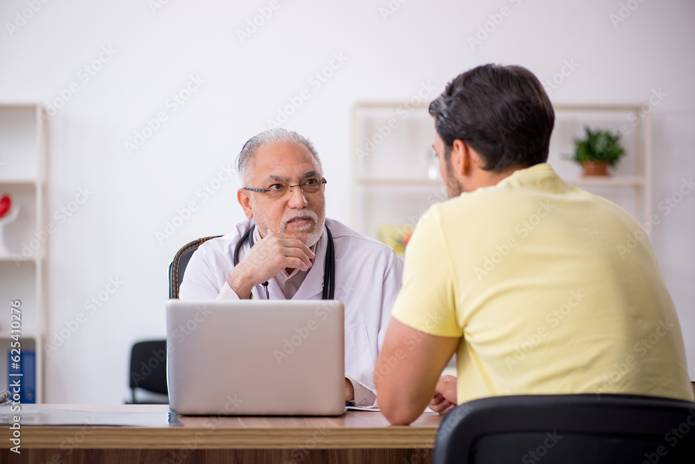 Young male patient visiting old male doctor Young male patient visiting old male doctor