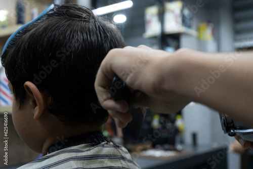 trimming process for a kid in a salon with brown straight hair