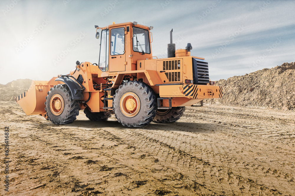 Wheel front loader or bulldozer at a construction site in a quarry. Powerful modern equipment for earthworks. Construction site. Rental of construction equipment. Wheel front loader or bulldozer at a construction site in a quarry. Powerful modern equipment for earthworks. Construction site. Rental of construction equipment.