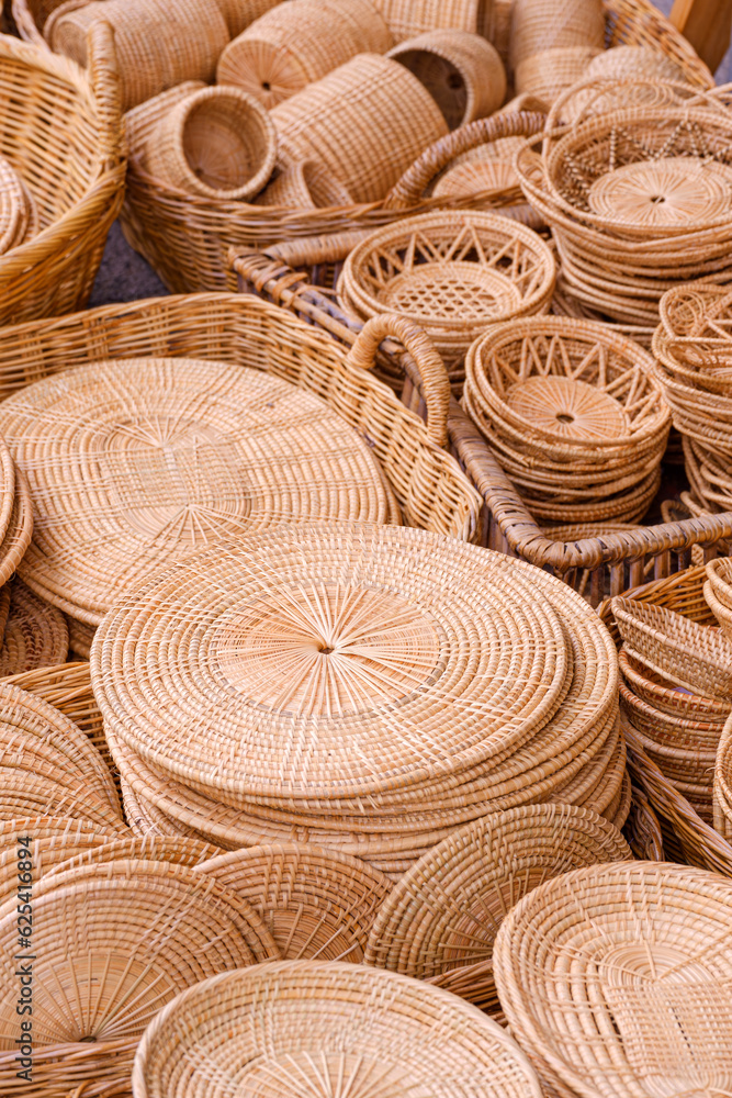 Group of many various handmade wicker trays and baskets for sale at Thailand street market, Basketry products background in vertical frame Group of many various handmade wicker trays and baskets for sale at Thailand street market, Basketry products background in vertical frame
