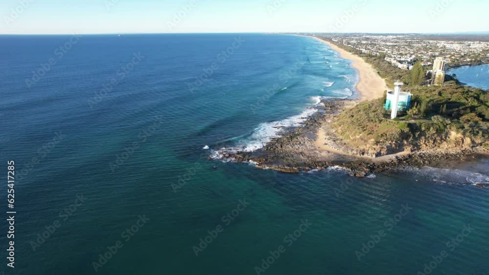 Point Cartwright Lighthouse On The Mouth Of Mooloolaba River. Coastal Landmark In Queensland, Australia. aerial sideways