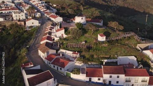 Wide shot of traditional Portuguese windmill at Odeceixe during sunrise, aerial photo