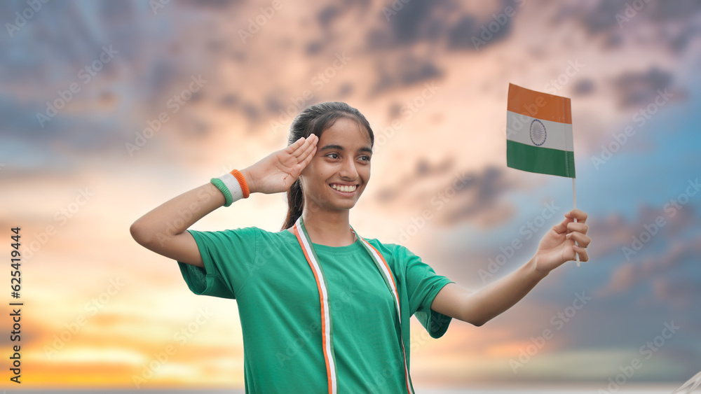 Cute Indian girl holding Indian flag in her hand and smiling