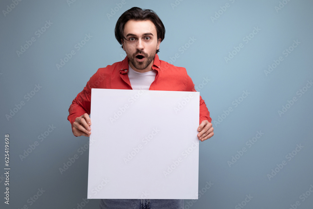 handsome caucasian brunet young man holding billboard with mockup handsome caucasian brunet young man holding billboard with mockup