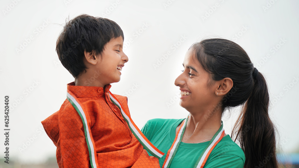 Cute brother and sister looking each other with smiling face. celebrating independence day or Republic Day. Cute brother and sister looking each other with smiling face. celebrating independence day or Republic Day.