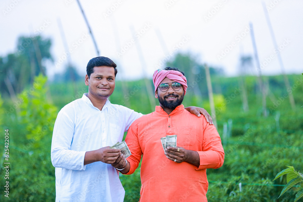 Indian farmer giving money to his worker