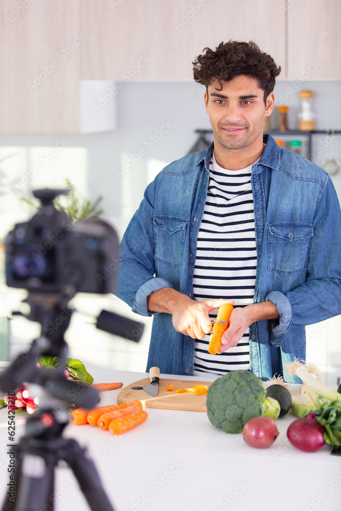 man filming himself preparing vegetables for a blog man filming himself preparing vegetables for a blog