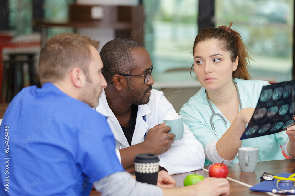 doctors looking at x-ray images in clinic