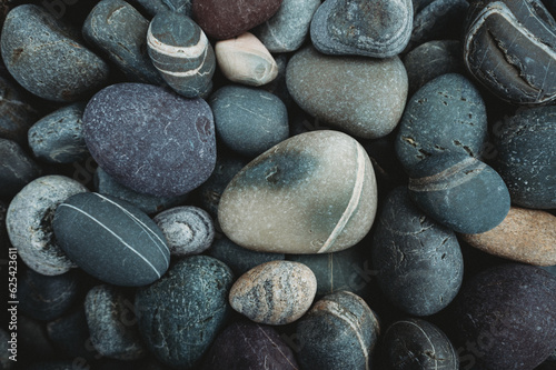 Close up of colorful smooth rocks on beach in Newfoundland, Canada.