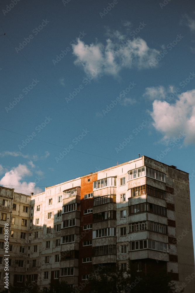Multistory building in sunlight and clouds