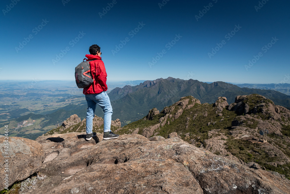 Beautiful view to man hiking on rocky mountains and altitude fields