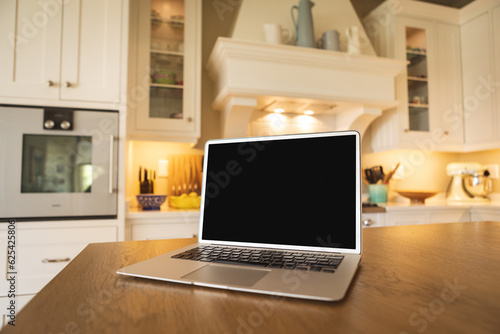 Wallpaper Mural Laptop with blank black screen placed on wooden table at home, copy space Torontodigital.ca