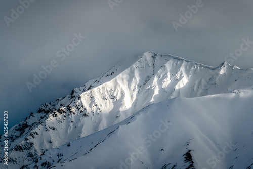 Canvas Print Sun in the snowcapped mountains