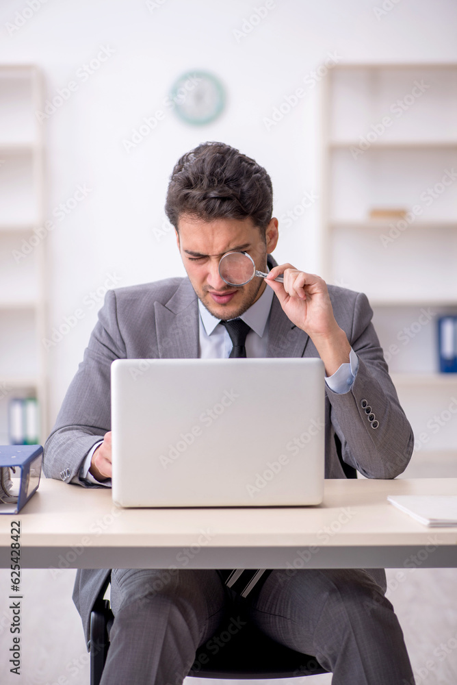 Young male employee working in the office Young male employee working in the office