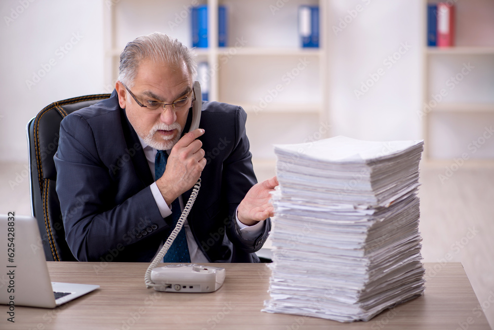 Old male employee and too much work in the office Old male employee and too much work in the office