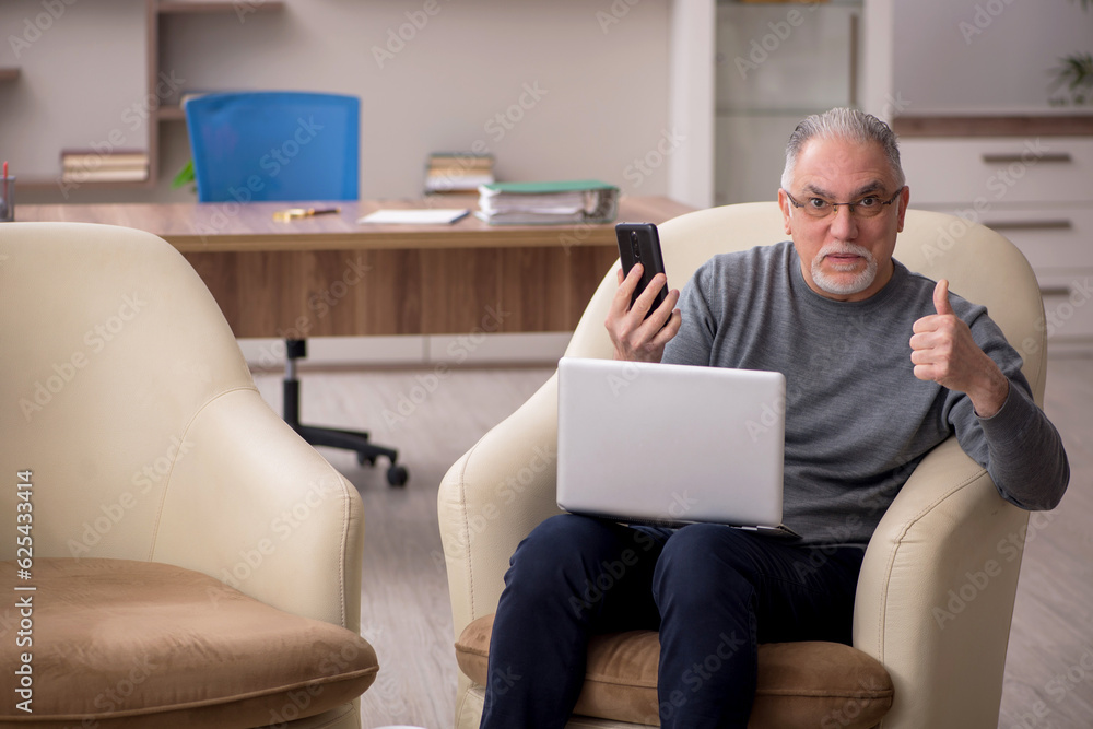 Old male employee working from home during pandemic Old male employee working from home during pandemic